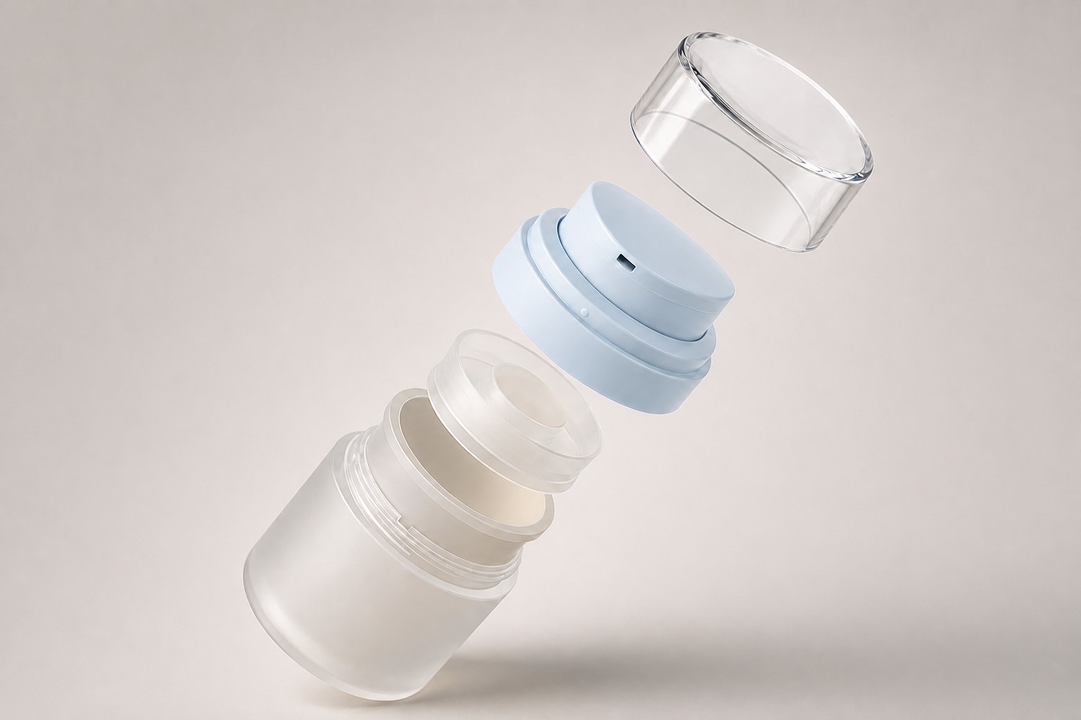 Exploded view of a jar separated into bottle, inner cup, closure assembly and clear overcap