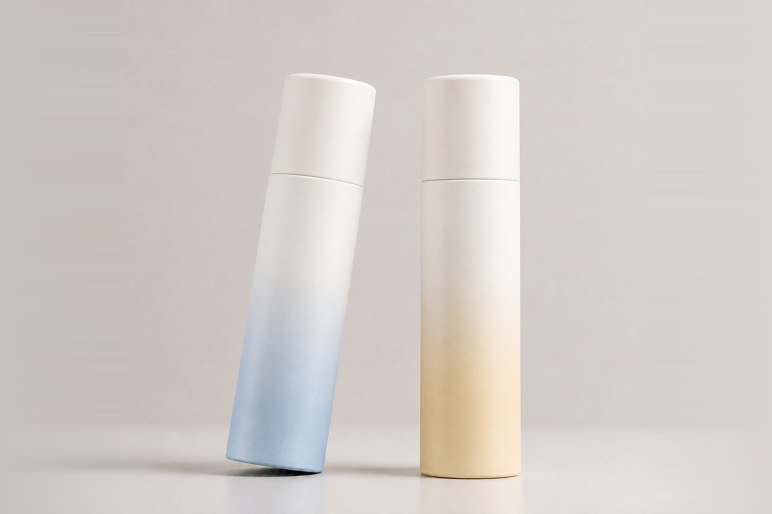 Two bottles with sprayed gradient finishes, one blue and one warm yellow